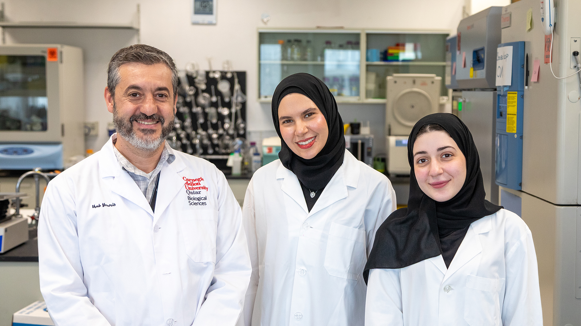 Ihab Younis with Mariam Elesnawy and Hana Hasna, two of the alumni co-authors, smiling at the camera.