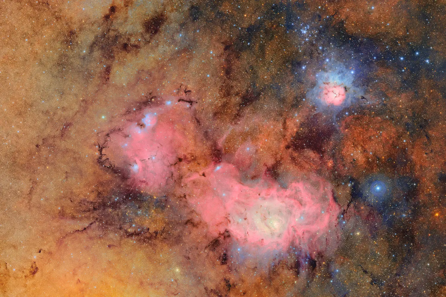 This image combines 678 separate images taken by NSF-DOE Vera C. Rubin Observatory in just over seven hours of observing time. Combining many images in this way clearly reveals otherwise faint or invisible details, such as the clouds of gas and dust that comprise the Trifid nebula (top right) and the Lagoon nebula, which are several thousand light-years away from Earth.