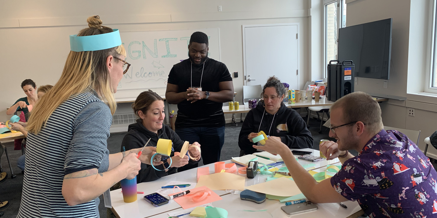 group of people around a table doing some crafts
