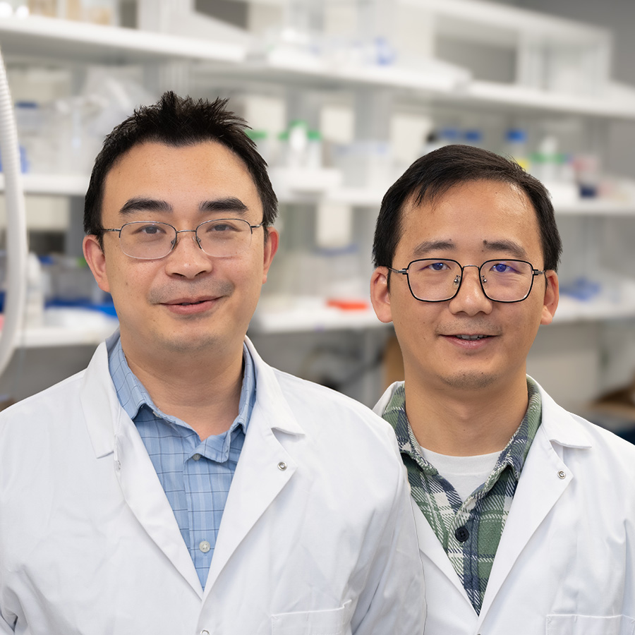 Zheng Kuang and Jianglin Zhang smile at the camera.