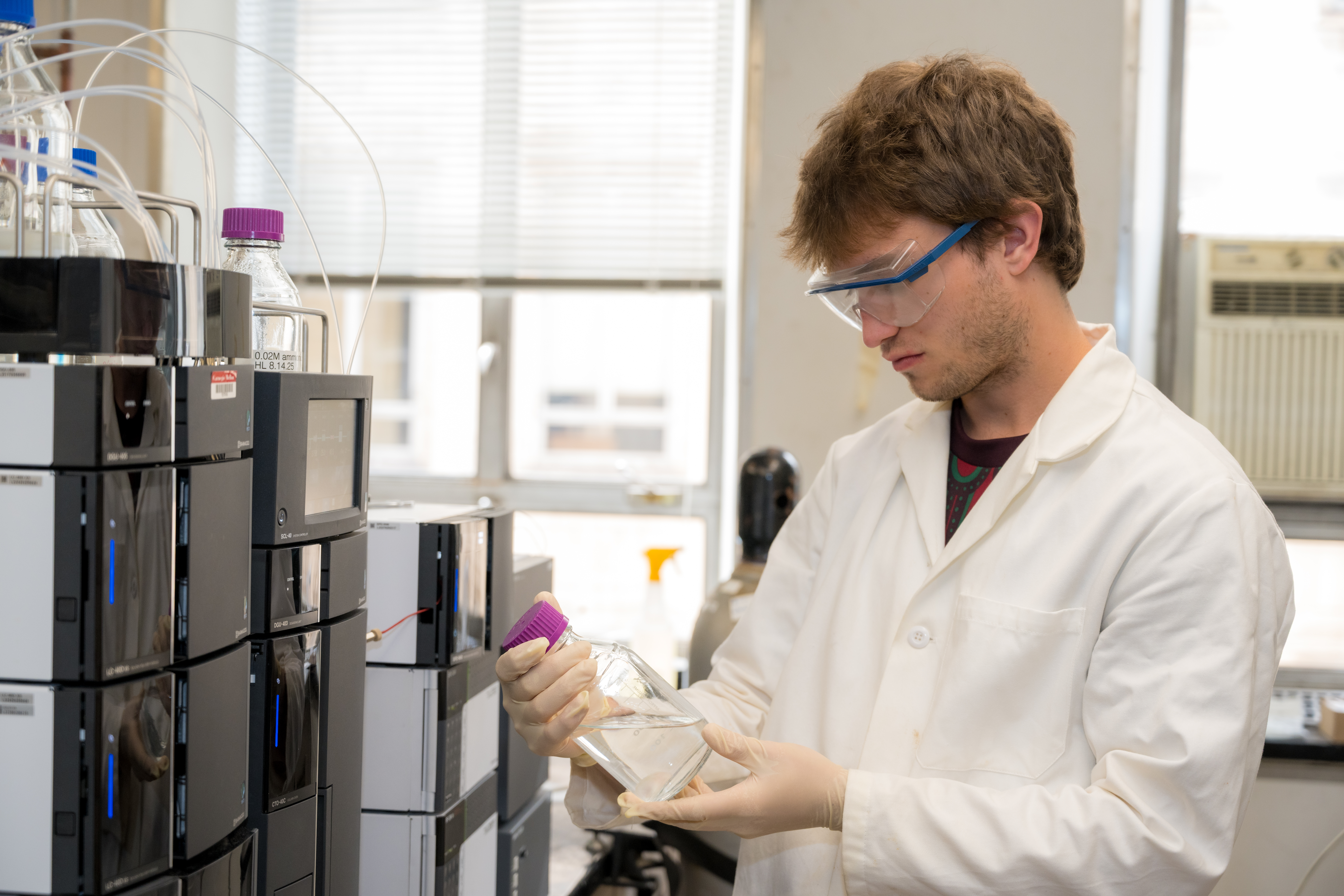 Keenan Norton examines a water sample in the lab.