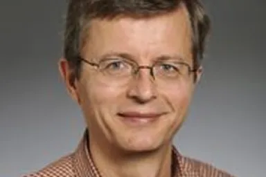 Randall Feenstra - man with light brown hair and glasses wearing a brown gingham button shirt