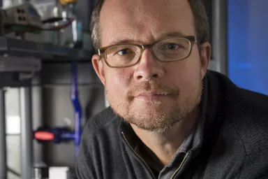 Newell Washburn - caucasian male wearing glasses leaning into the camera