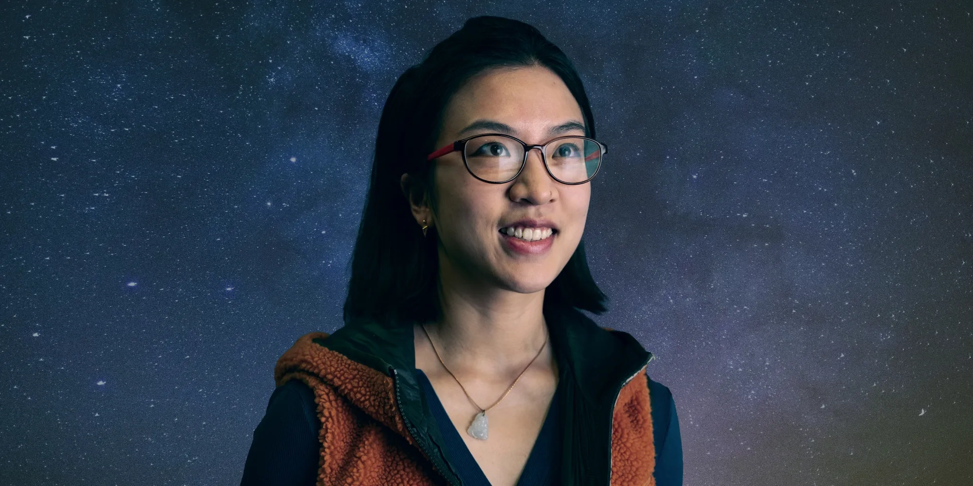 Nianyi Chen stands against a galaxy background.