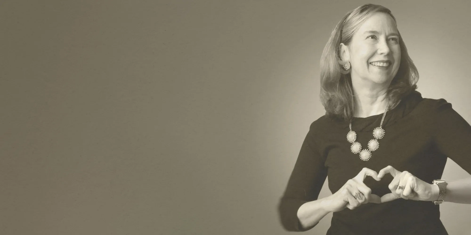 Karen Stump making a heart shape with her hands.