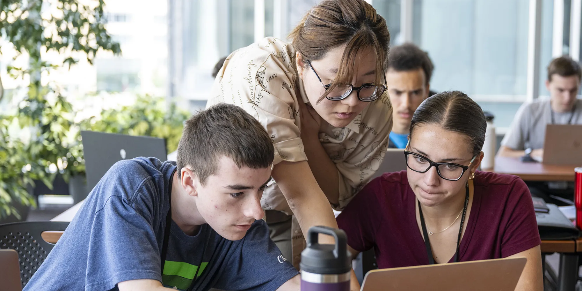 Students receive guidance from an instructor.