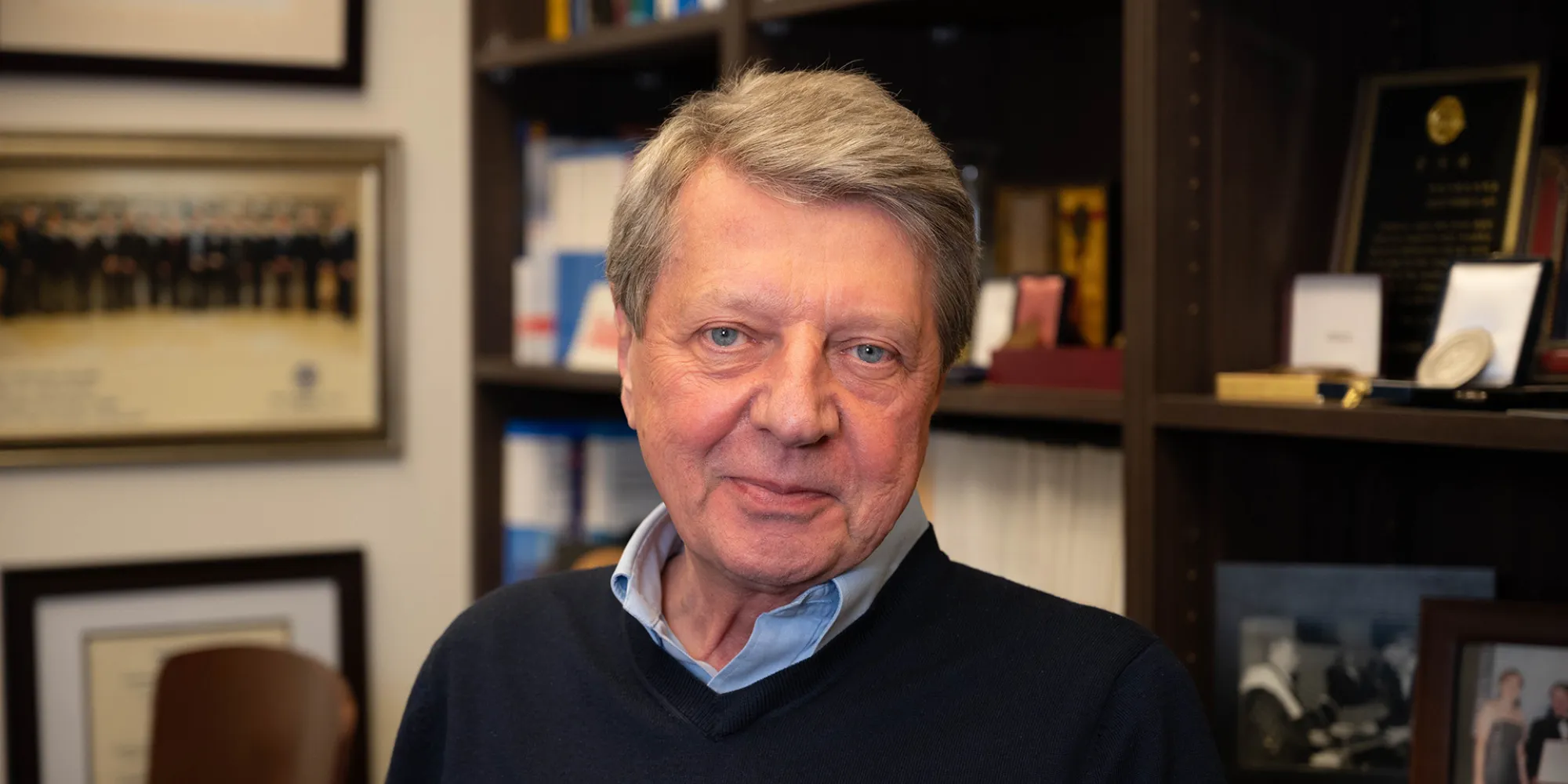 Krzysztof Matyjaszewski posing in his office with a slight smile.