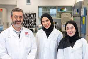 Ihab Younis with Mariam Elesnawy and Hana Hasna, two of the alumni co-authors, smiling at the camera.