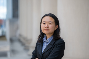 Katherine Wang stands outside of Mellon Institute. She looks into the camera.