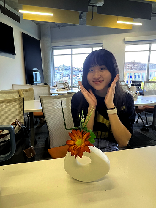 Briana poses with an arrangement