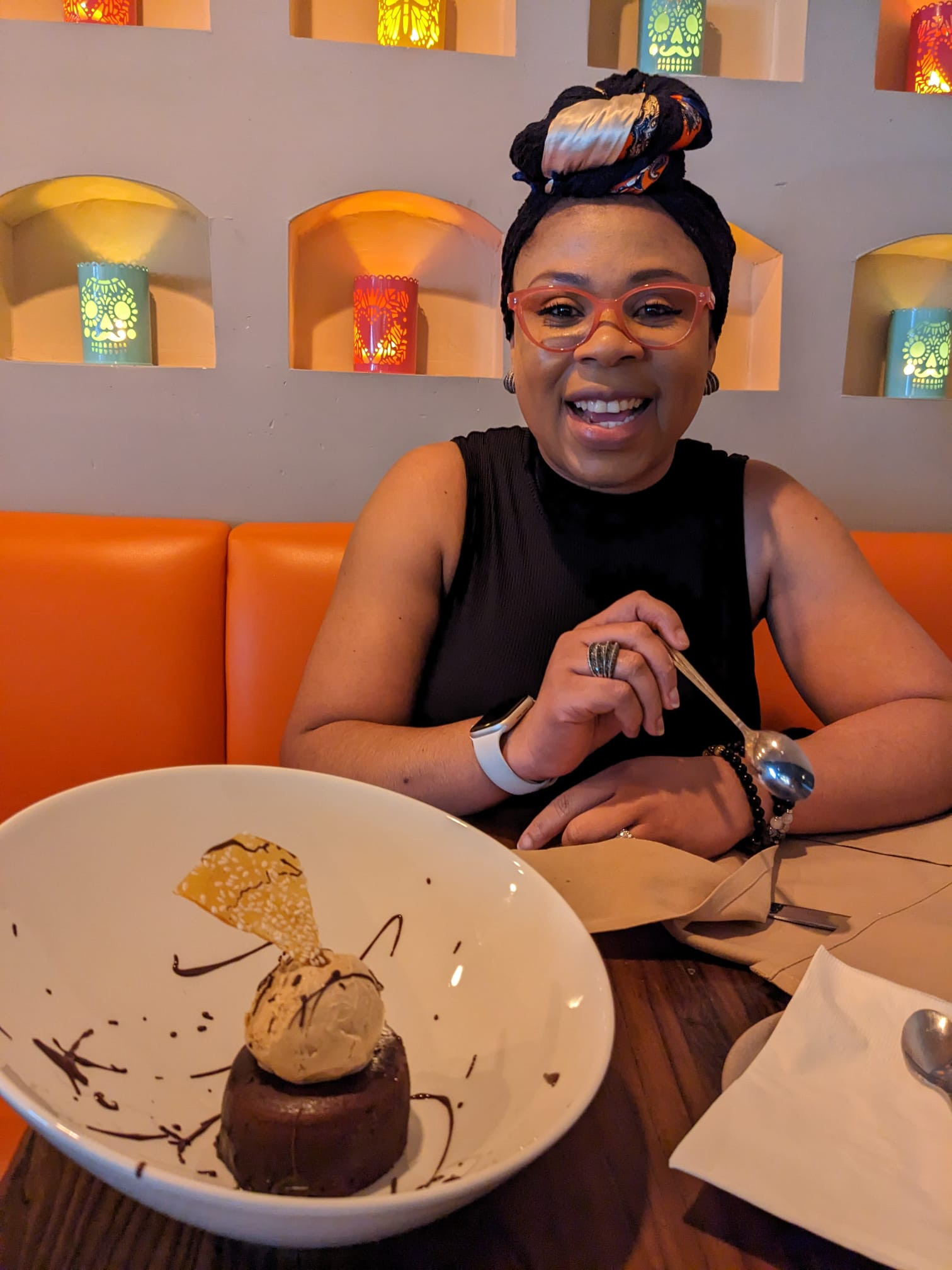Ozioma posing with a dessert on a table