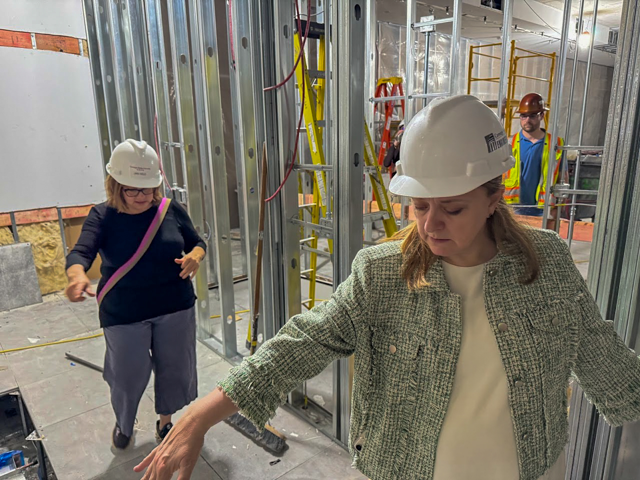 Dean Isabelle Bajeux walks through construction