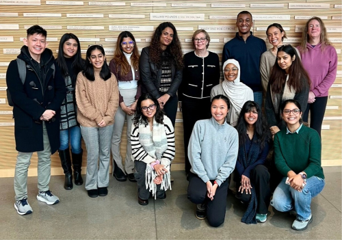 A photo of Cathy Young standing with a group of students
