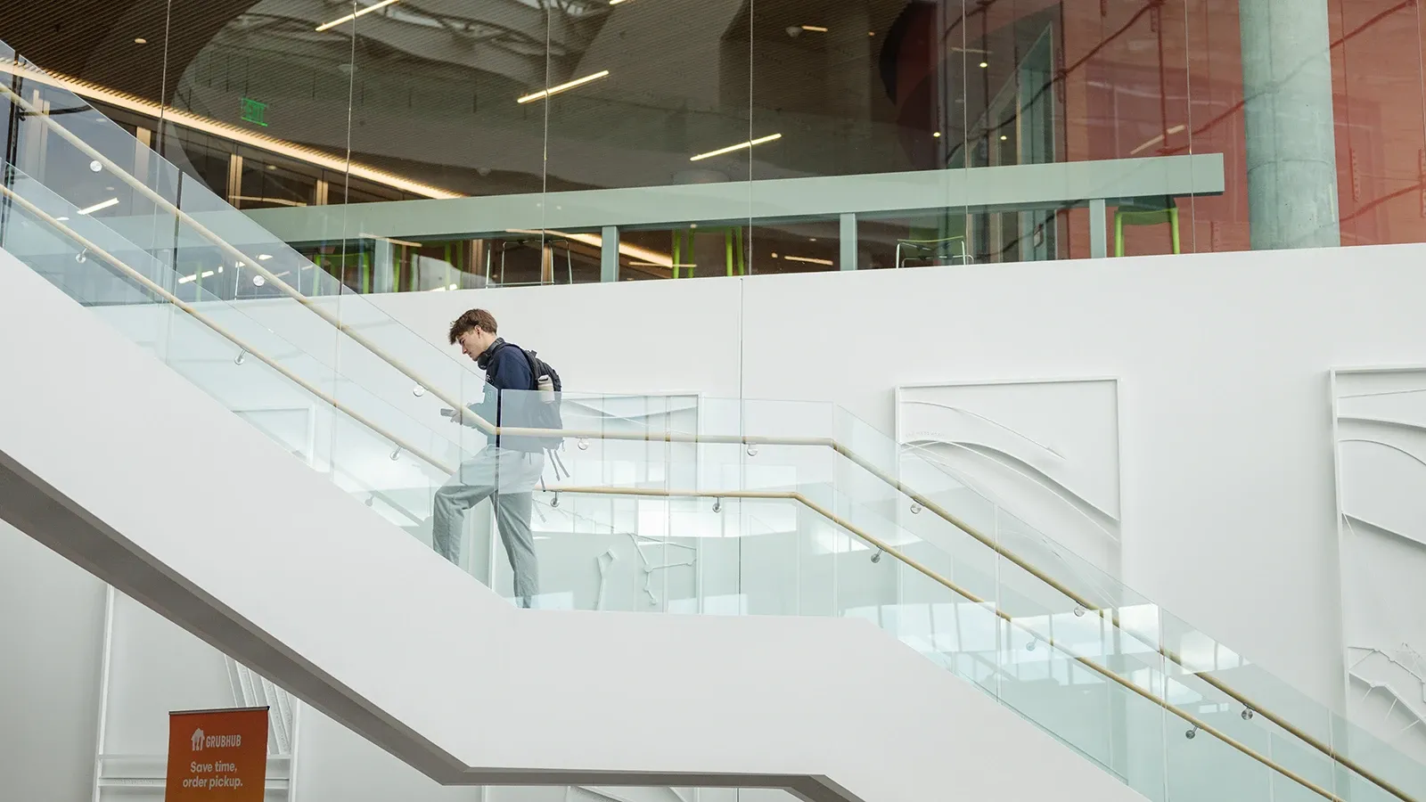 A student walking up a set of stairs.