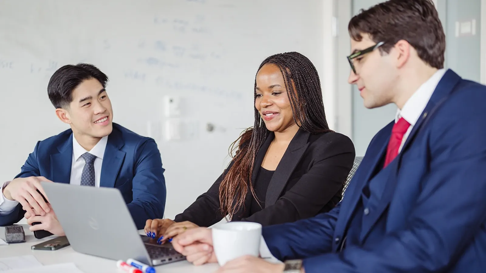 Three MSBA students collaborating on a project.