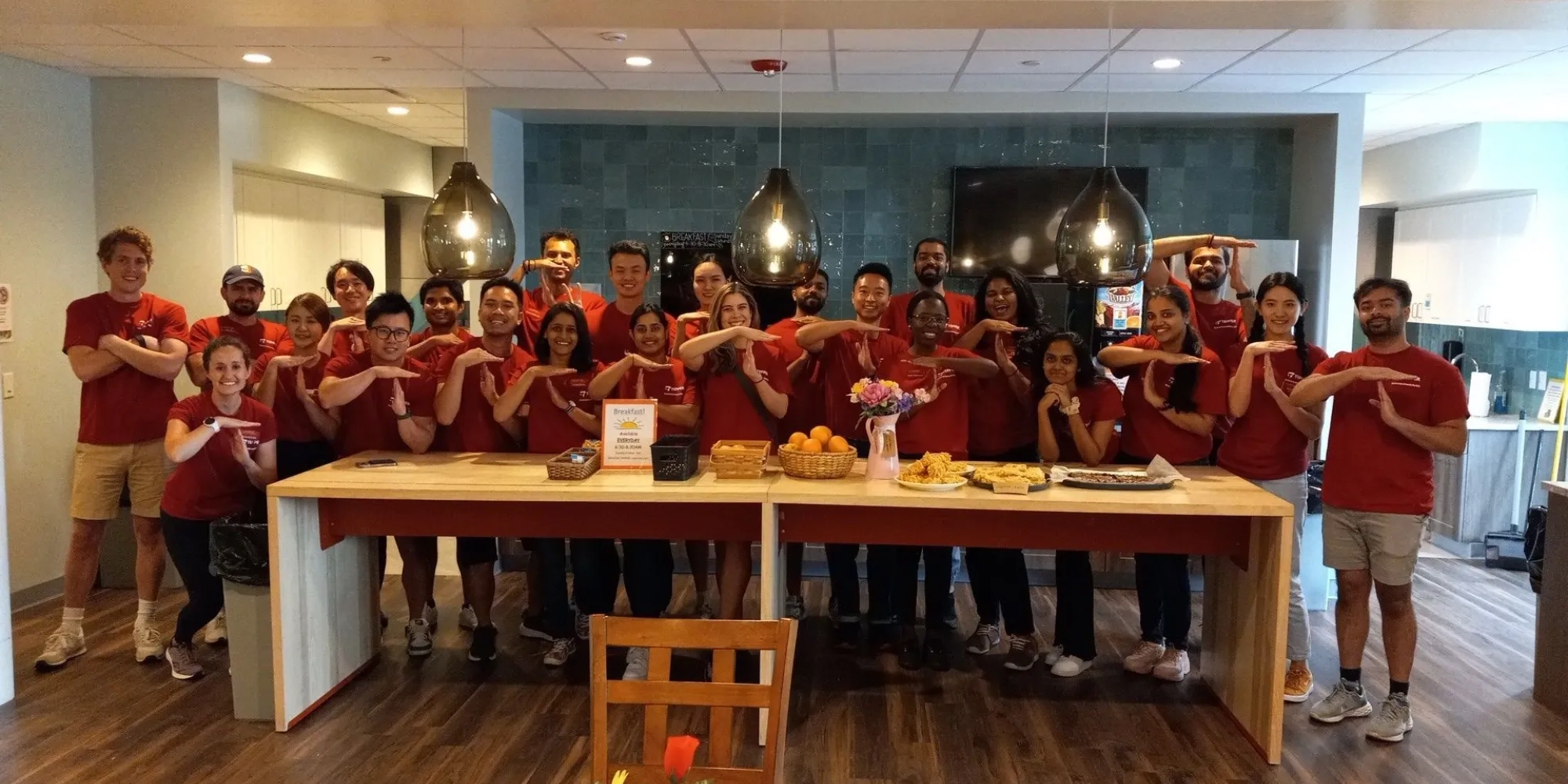 A group of students holding their hands in the shape of Ts