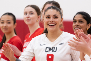 A photo of Zoe Gavros standing with the volleyball team