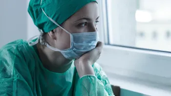 Photo of surgeon after surgery looking concerned