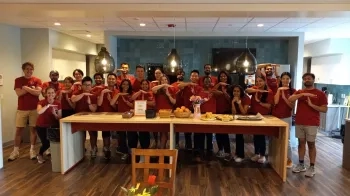 A group of students holding their hands in the shape of Ts