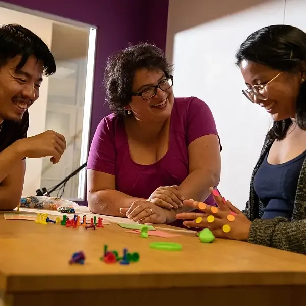 Group of academics working on a prototype table top game