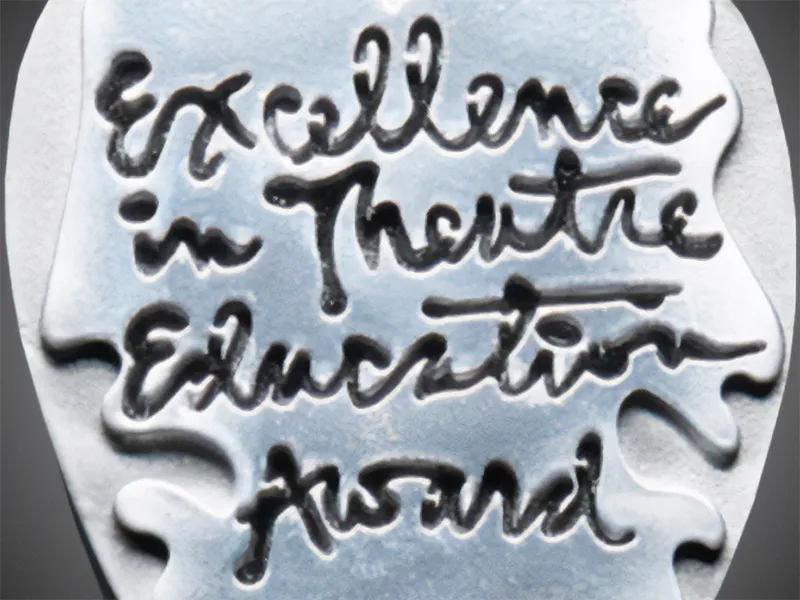 Close up of the designed Excellence in Theatre Education Award.