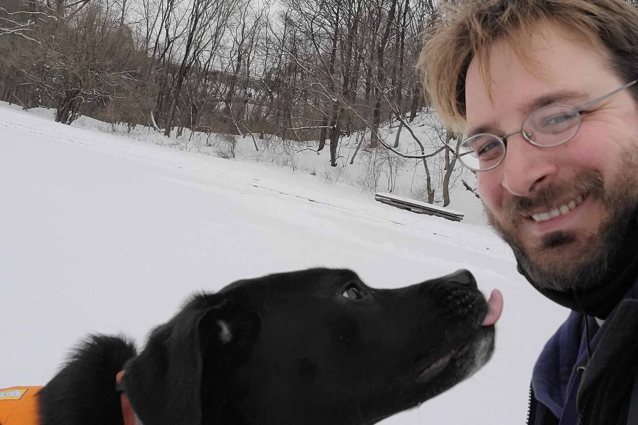Andrew Ramey and his dog in the snow