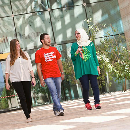 students walking across CMU Qatar's campus