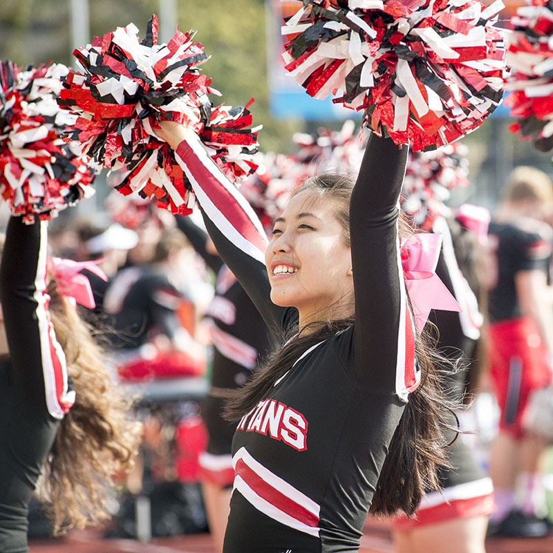 Photo of a cheerleader in her uniform at a game
