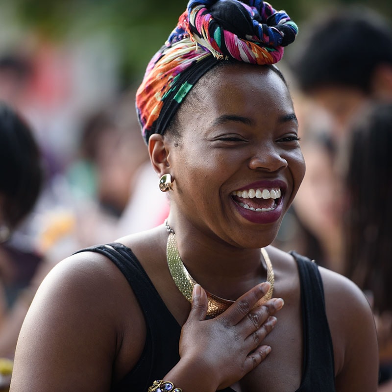 Photo of a young woman smiling and laughing