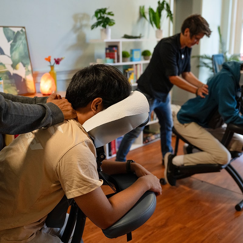 Students take a moment to relax in massage chairs in the Highmark Center for Health, Wellness, and Athletics