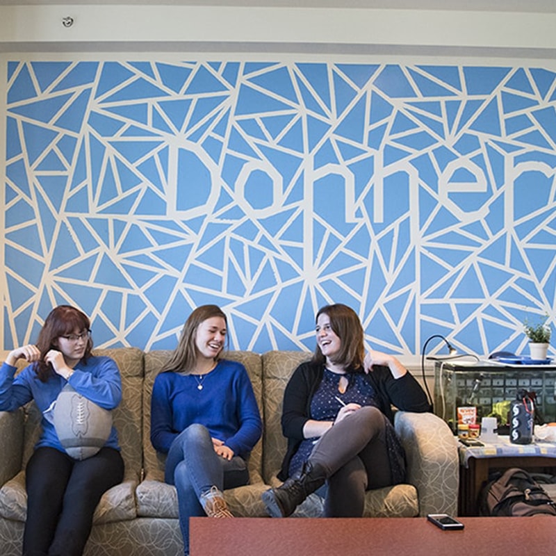 Photo of students sitting in Donner House, smiling