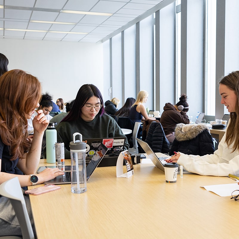 CMU students together at a table in Hunt Library.