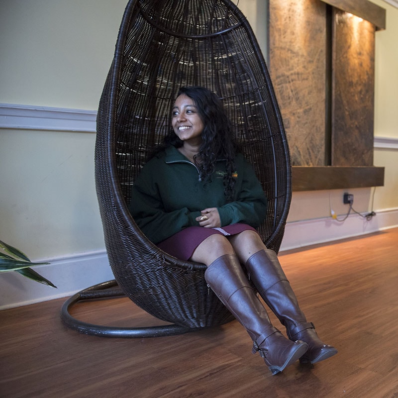 Photo of female student sitting in the Mindfulness Room