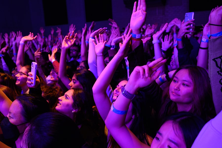 CMU students at a concert with purple lights shining onto the crowd