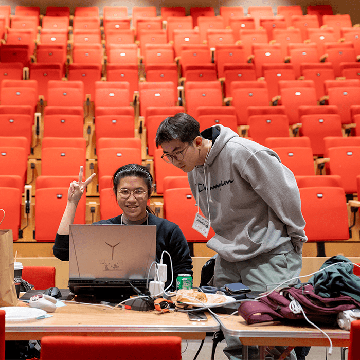 Students and community members gather around laptops to work on their games during Global Game Jam at Simmons Auditorium in Tepper Hall.