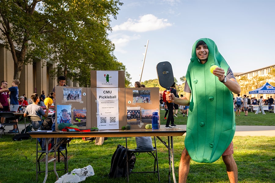 a student in a pickle costume at the FAIR