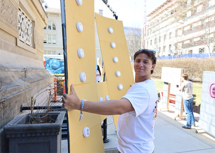 Fraternity member carries in props for the Greek Sing set into Soldiers and Sailors Hall.
