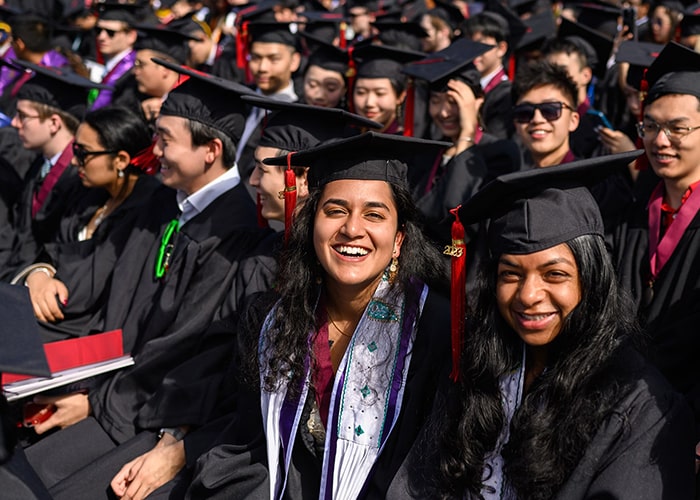 Students in caps and gowns on graduation day in Gesling Stadium
