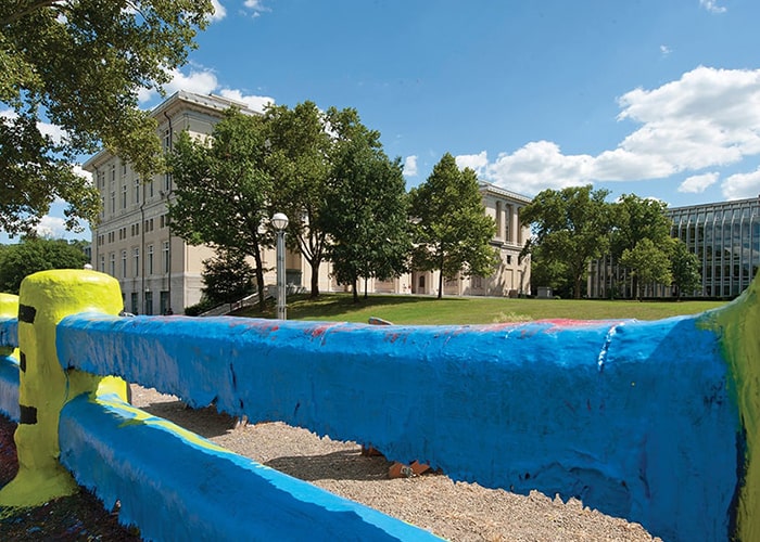 The Fence painted blue and yellow under a blue sky