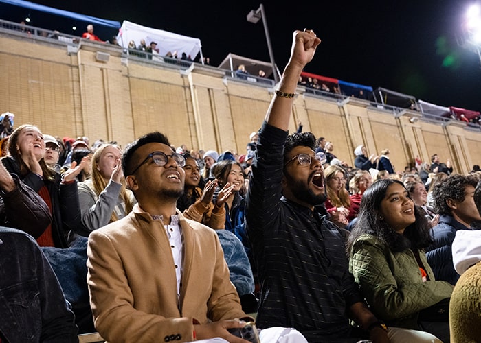 Students and families cheering in Gesling Stadium at Homecoming