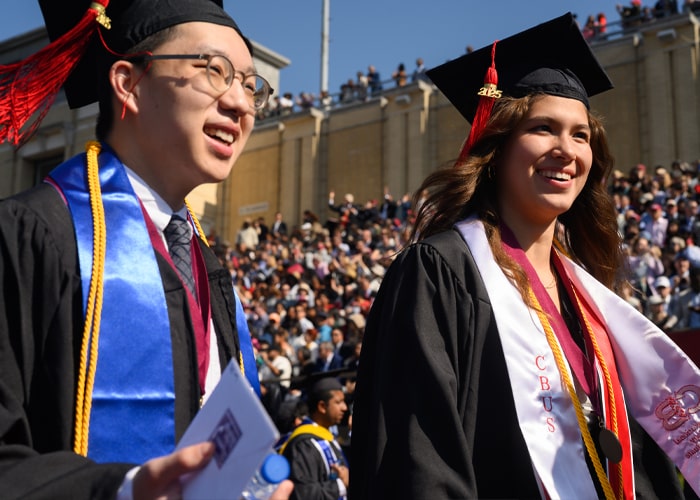 Students are dressed in their cap and gowns at Commencement