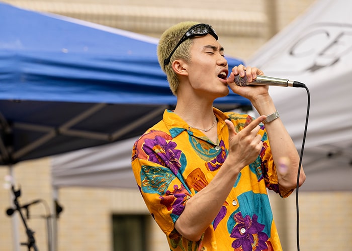 Student belts out into a microphone for his performance at Scotty Saturday