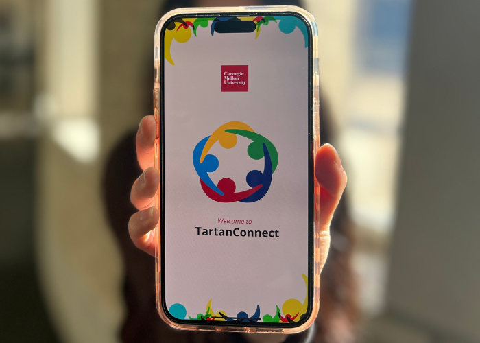 Student showing TartanConnect application on phone