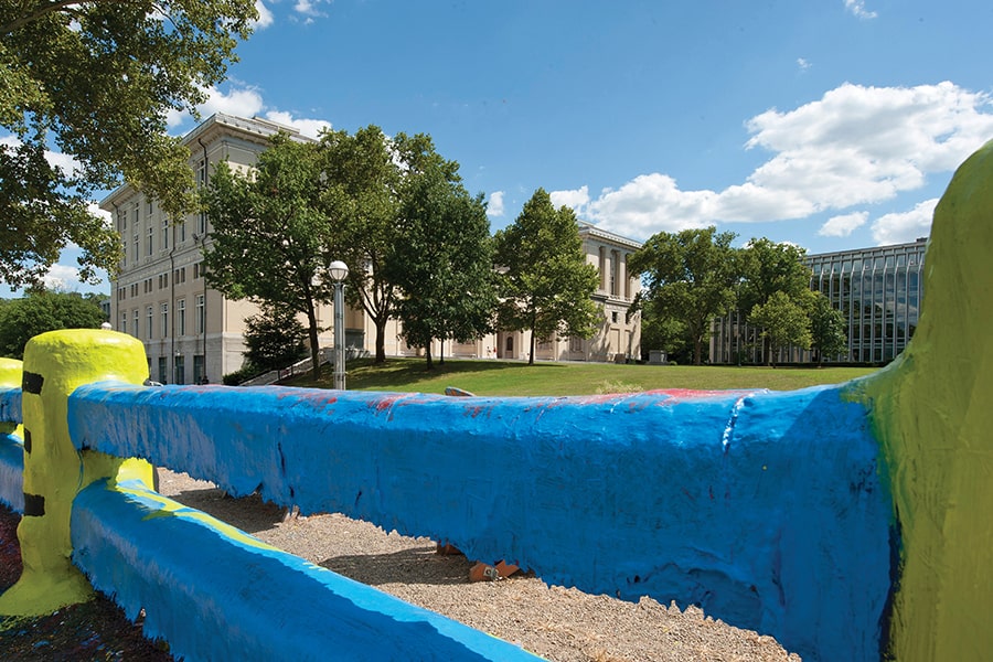 the fence painted blue and yellow under a blue sky