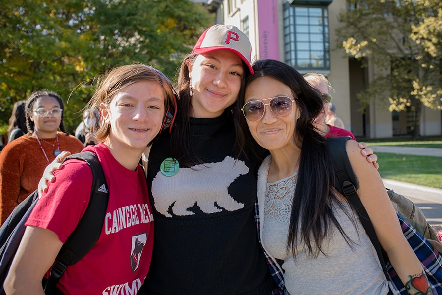 three family members smiling for the camera