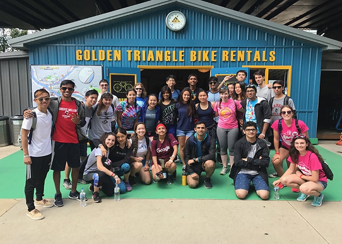 a group of student getting ready to rent bikes and ride through the city