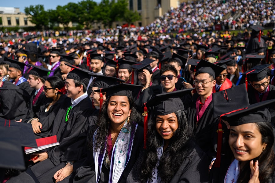 students in caps and gowns on graduation day in gesling stadium