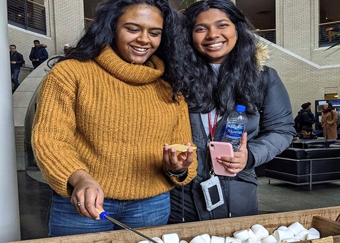 Students smiling in the Cohon Center with s'mores