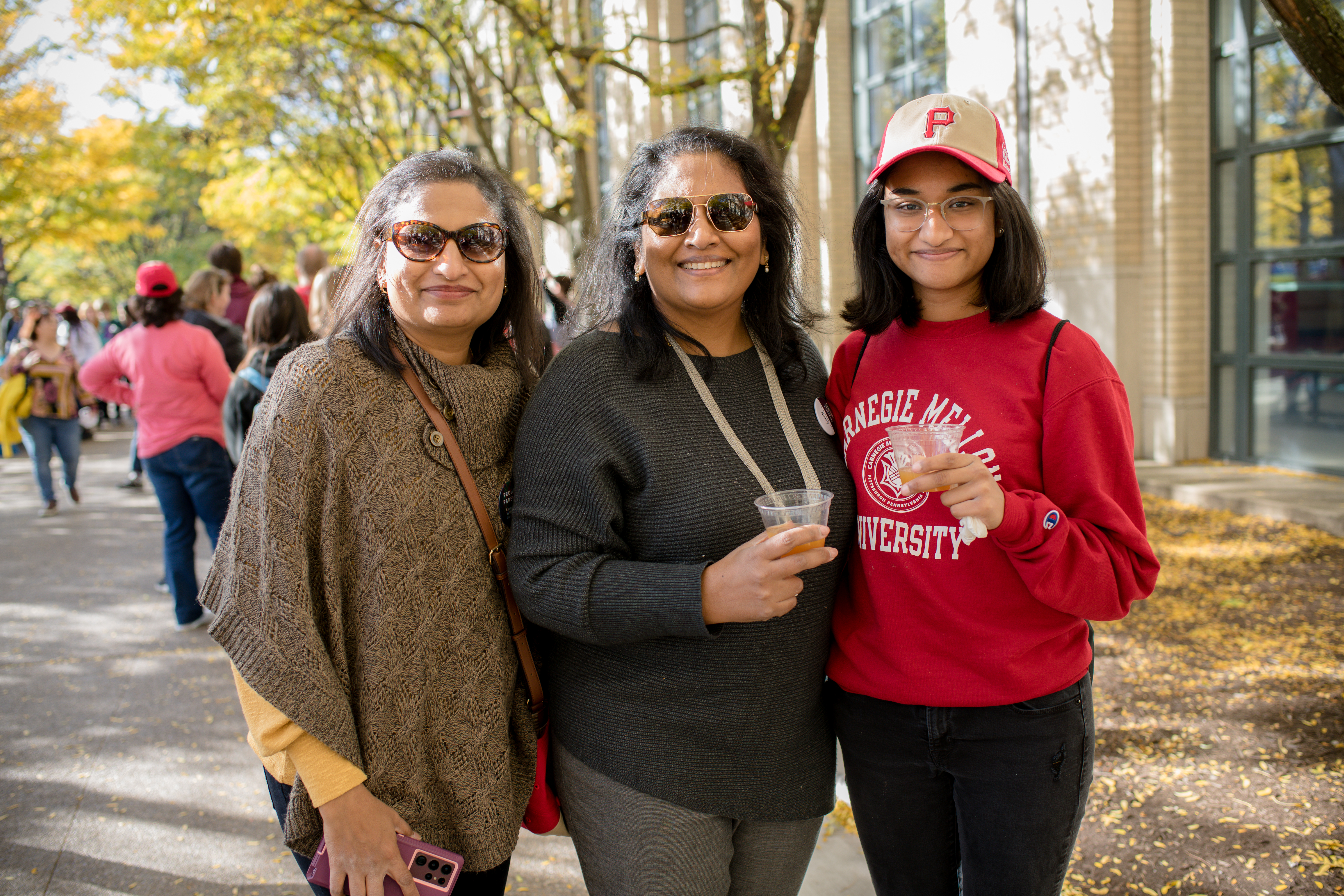 photo of three women standing together and smiling