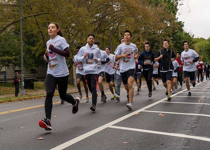 Students running down road at the Donut Dash